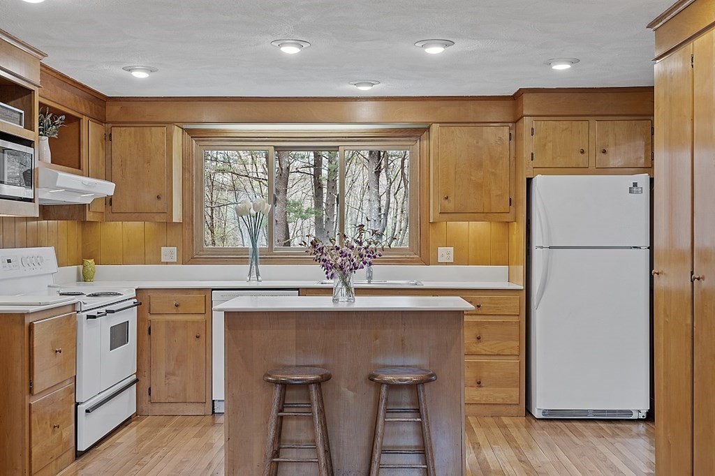 13 Eldridge Road Harvard, MA 01451 - Photo 11 of 40 a kitchen with a sink a stove a refrigerator and cabinets