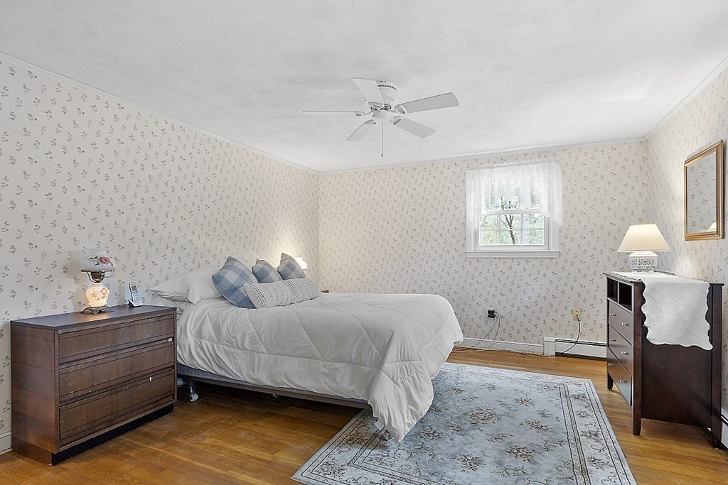 13 Eldridge Road Harvard, MA 01451 - Photo 28 of 40 a bedroom with a bed and wooden floor