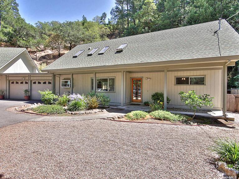front view of a house with a bench