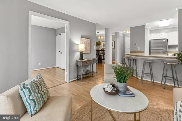 a living room with furniture and a dining table