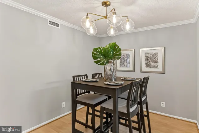 a view of a dining room with a table and chairs