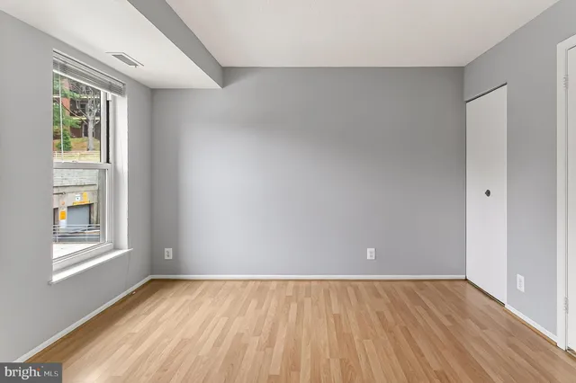 wooden floor in an empty room with a window