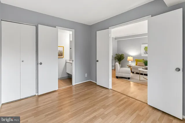 a view of living room and bedroom with wooden floor