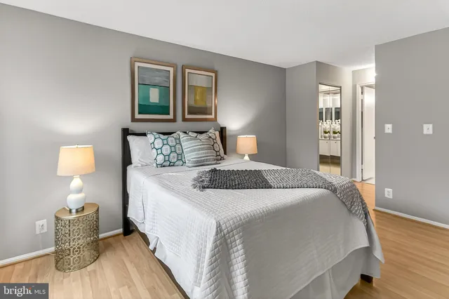 a bedroom with bed and wooden floor