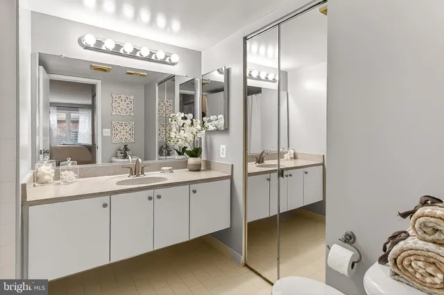 a bathroom with a double vanity sink and mirror