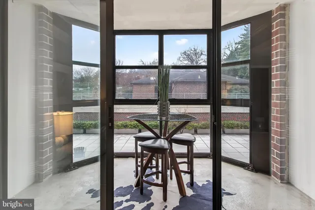 a view of a room with a table and chairs