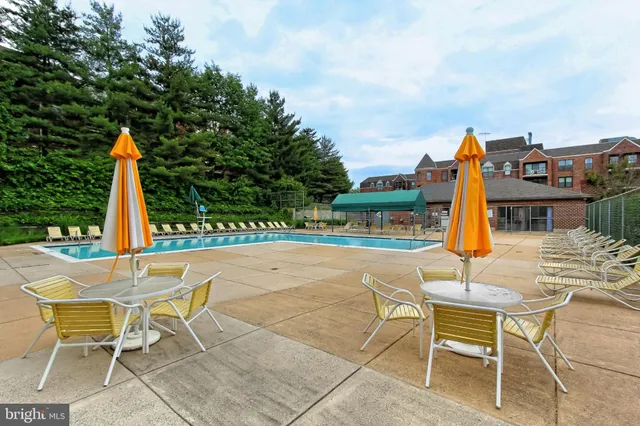 a view of a swimming pool with a table and chairs