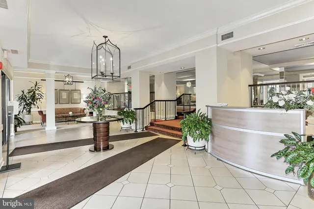 a view of living room with furniture and a chandelier