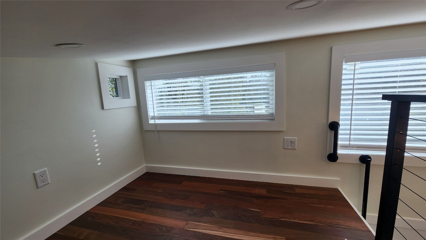 1134 Lott Avenue Austin, TX 78721 - Photo 12 of 32 a view of an empty room with wooden floor and a window