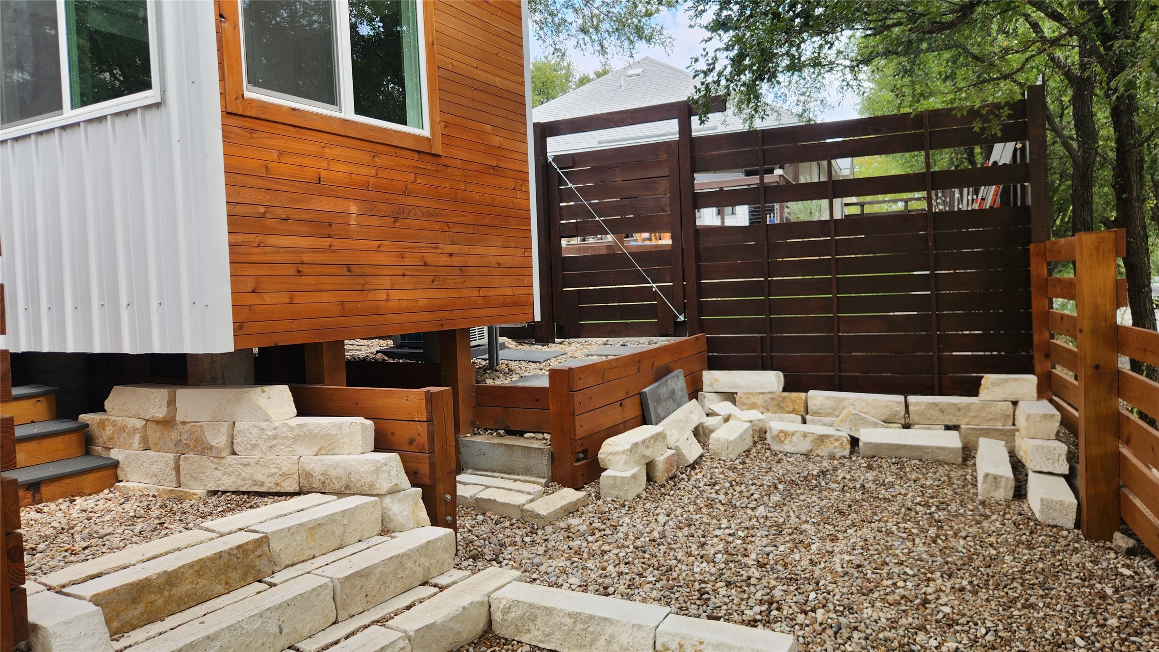 1134 Lott Avenue Austin, TX 78721 - Photo 24 of 32 The patio area to the right with storage below and steps to entrance.