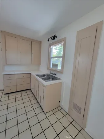 a kitchen with a sink a stove and cabinets