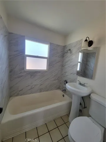 a bathroom with a sink a toilet and bathtub