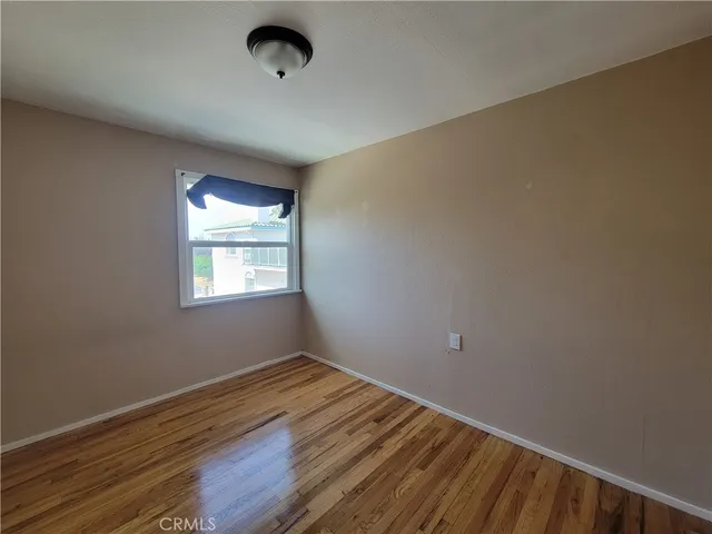 a view of a room with wooden floor and windows