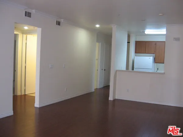 a view of a room with wooden floor and a window