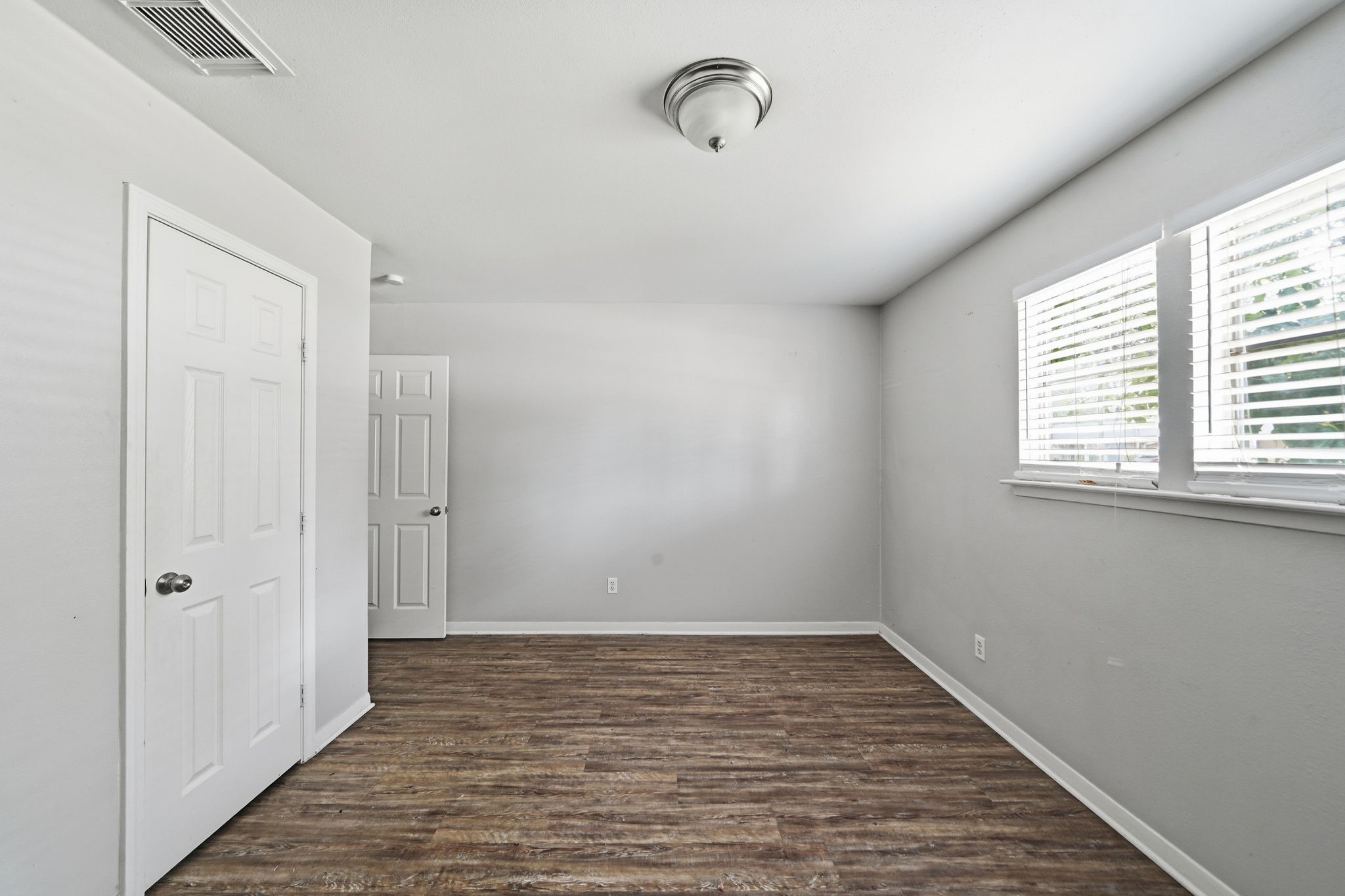 6410 Hopper Road Houston, TX 77016 - Photo 22 of 28 a view of a room with wooden floor and windows