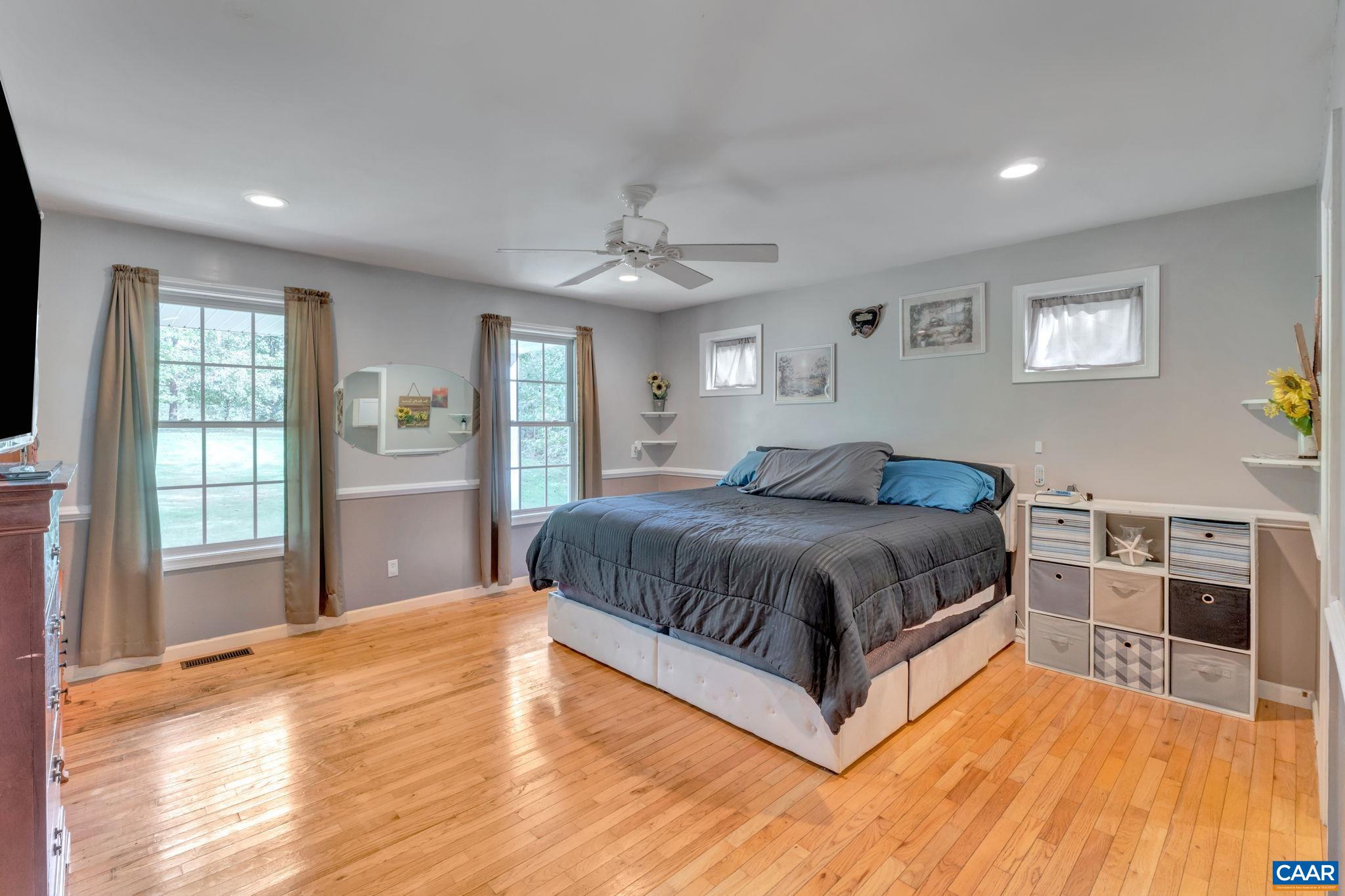 193 Jordan Store Road Kents Store, VA 23084 - Photo 15 of 45 a spacious bedroom with a large bed and a flat screen tv