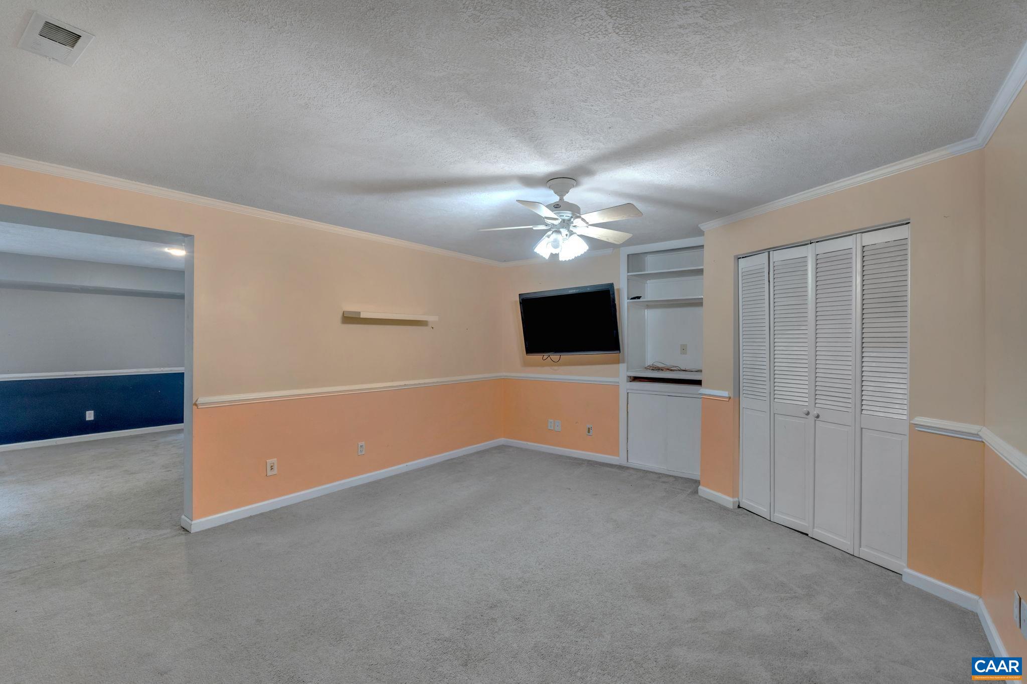 193 Jordan Store Road Kents Store, VA 23084 - Photo 28 of 45 an empty room with chandelier fan and kitchen view