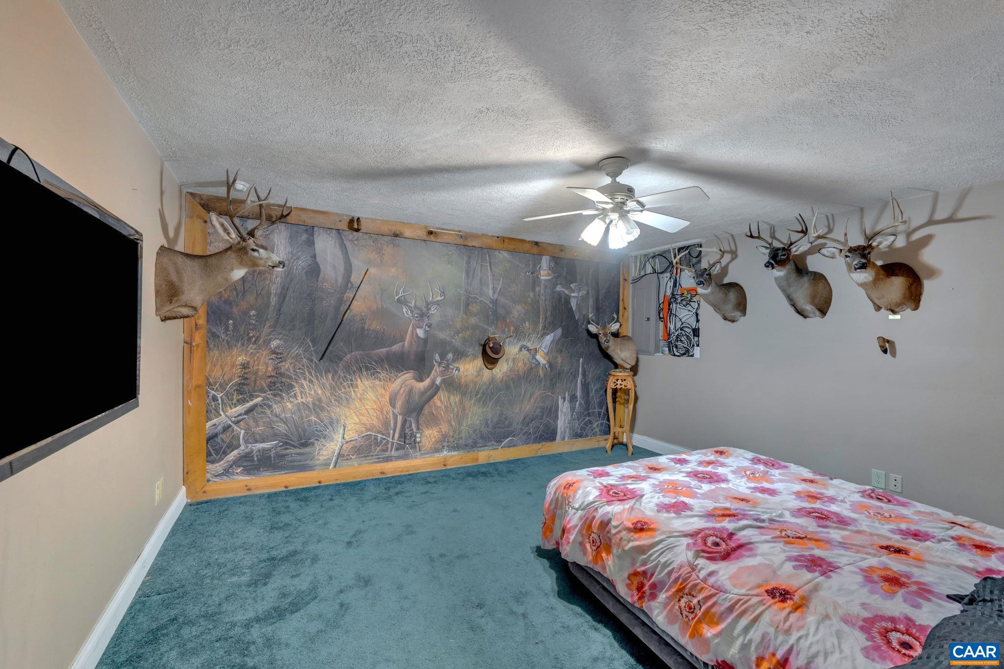 193 Jordan Store Road Kents Store, VA 23084 - Photo 32 of 45 a bedroom with a bed and a chandelier