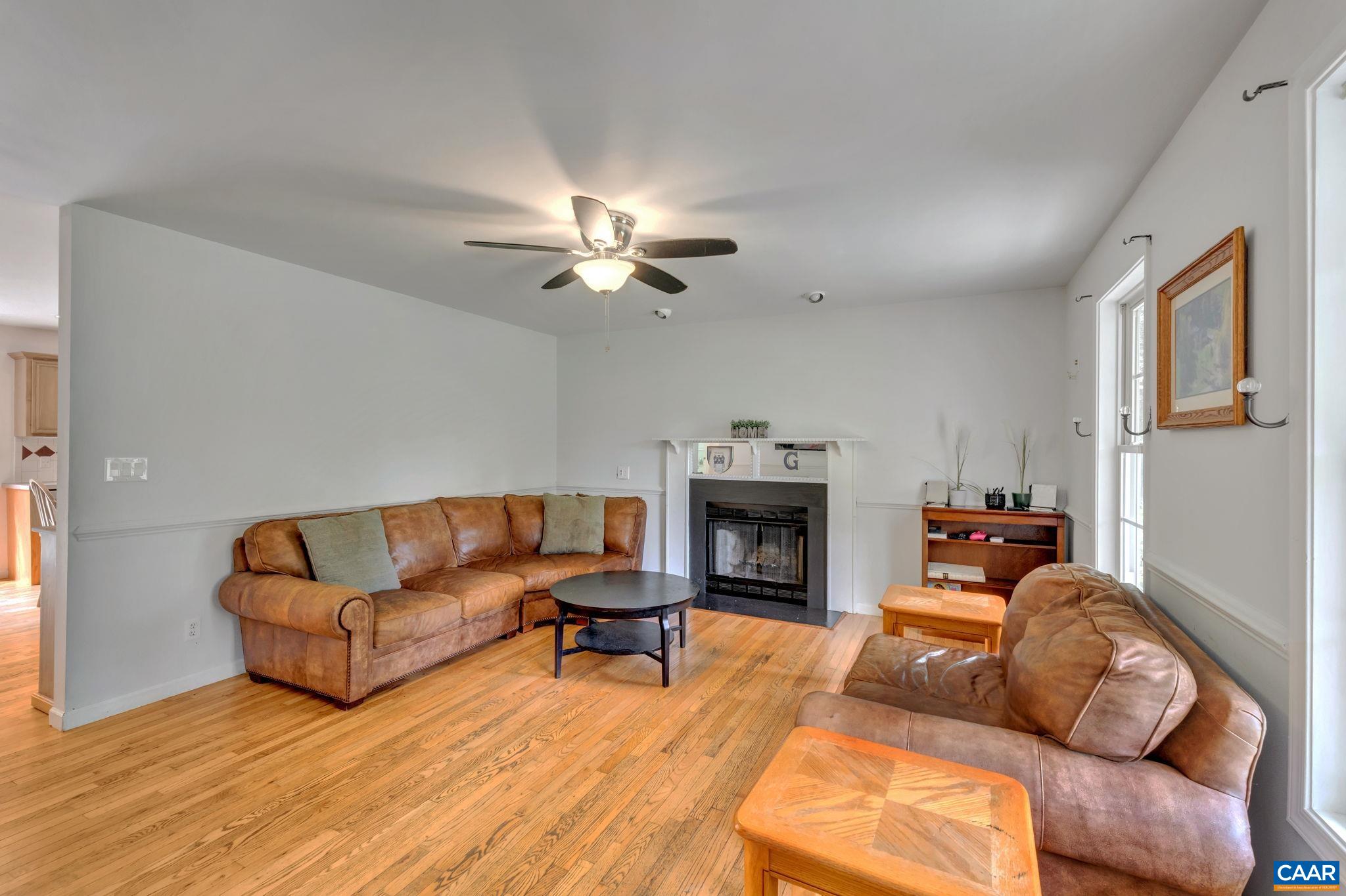 193 Jordan Store Road Kents Store, VA 23084 - Photo 4 of 45 a living room with furniture a fireplace and a ceiling fan