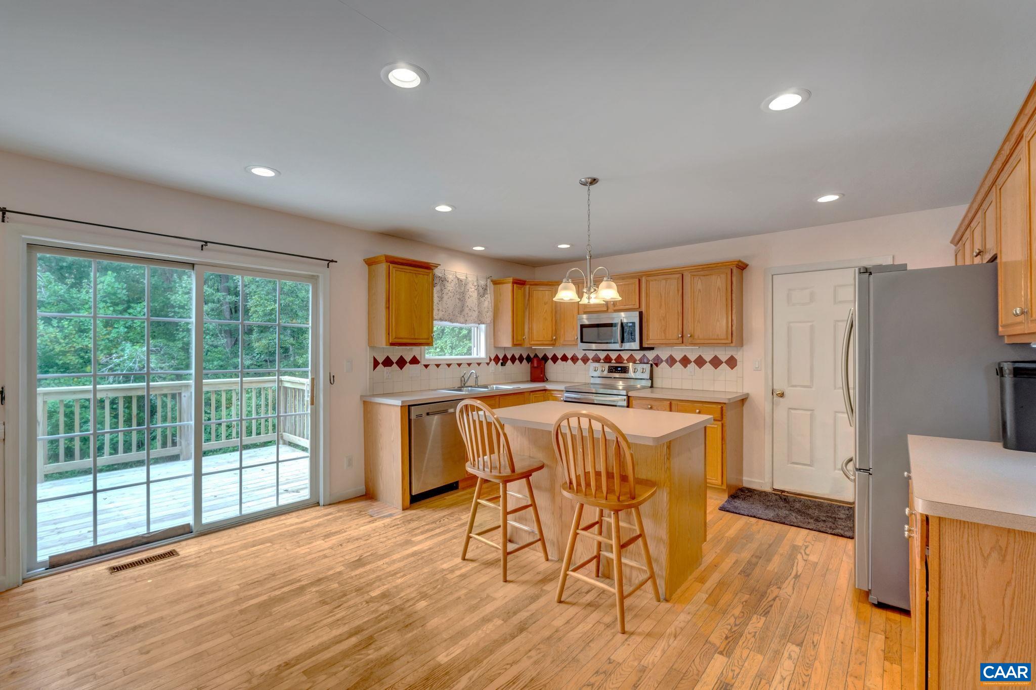 193 Jordan Store Road Kents Store, VA 23084 - Photo 8 of 45 a kitchen with a table chairs refrigerator and microwave