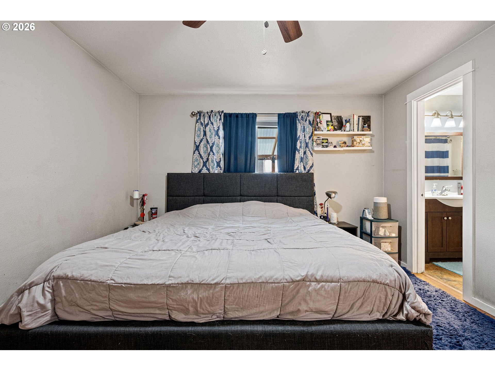 1055 Ash Grove Loop Creswell, OR 97426 - Photo 17 of 33 a bedroom with a bed and wooden floor