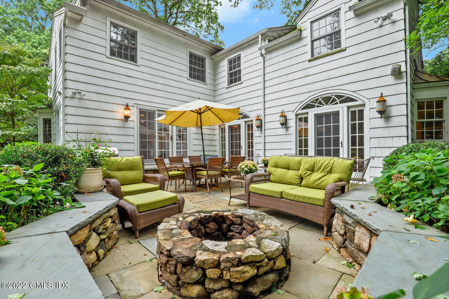 20 Crescent Road Riverside, CT 06878 - Photo 35 of 46 a view of a patio with couches table and chairs under an umbrella