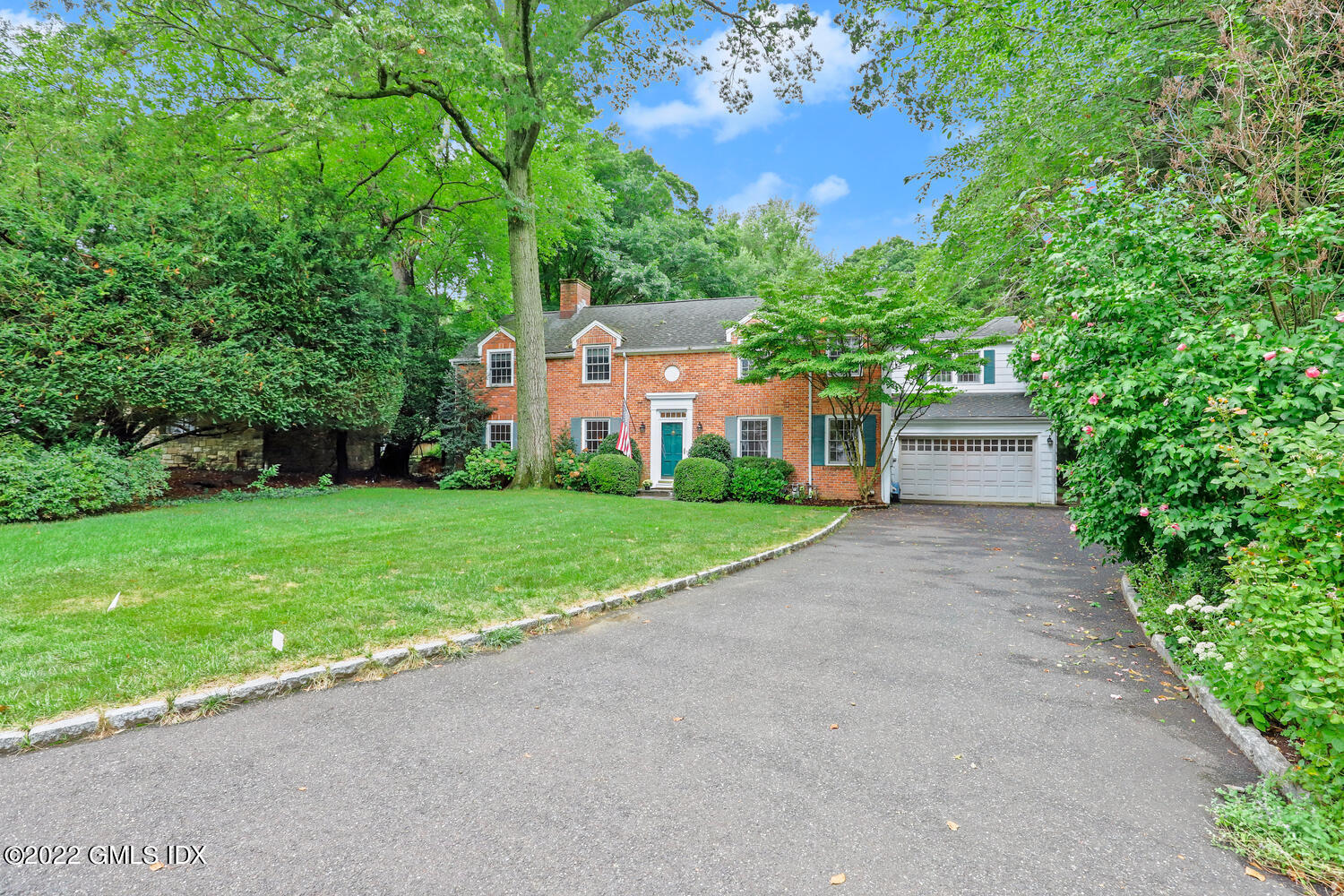 20 Crescent Road Riverside, CT 06878 - Photo 4 of 46 a front view of a house with a yard and a garage