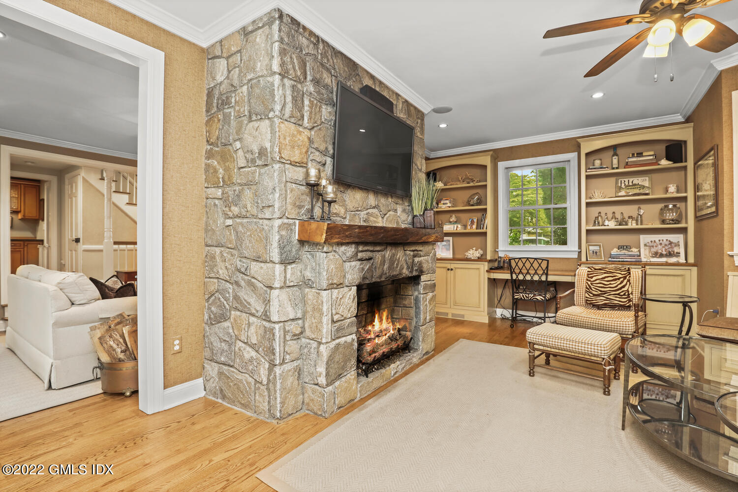 20 Crescent Road Riverside, CT 06878 - Photo 10 of 46 a living room with furniture a fireplace and a flat screen tv