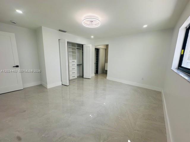 11870 Southwest 5th Street, Unit 1 Miami, FL 33184 - Photo 21 of 38 an empty room with closet and windows