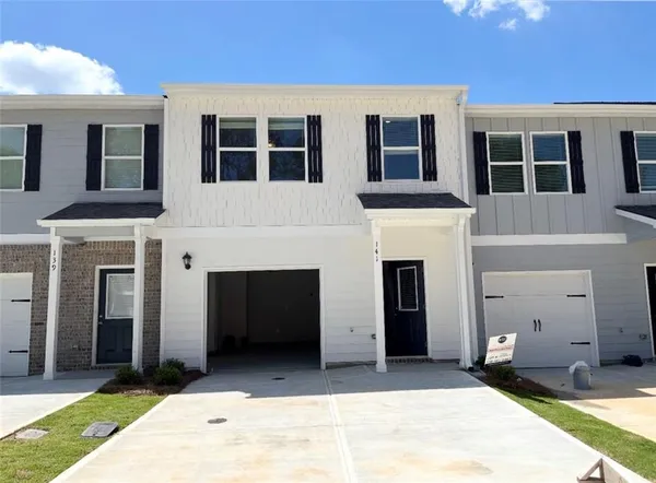 a front view of a house with yard