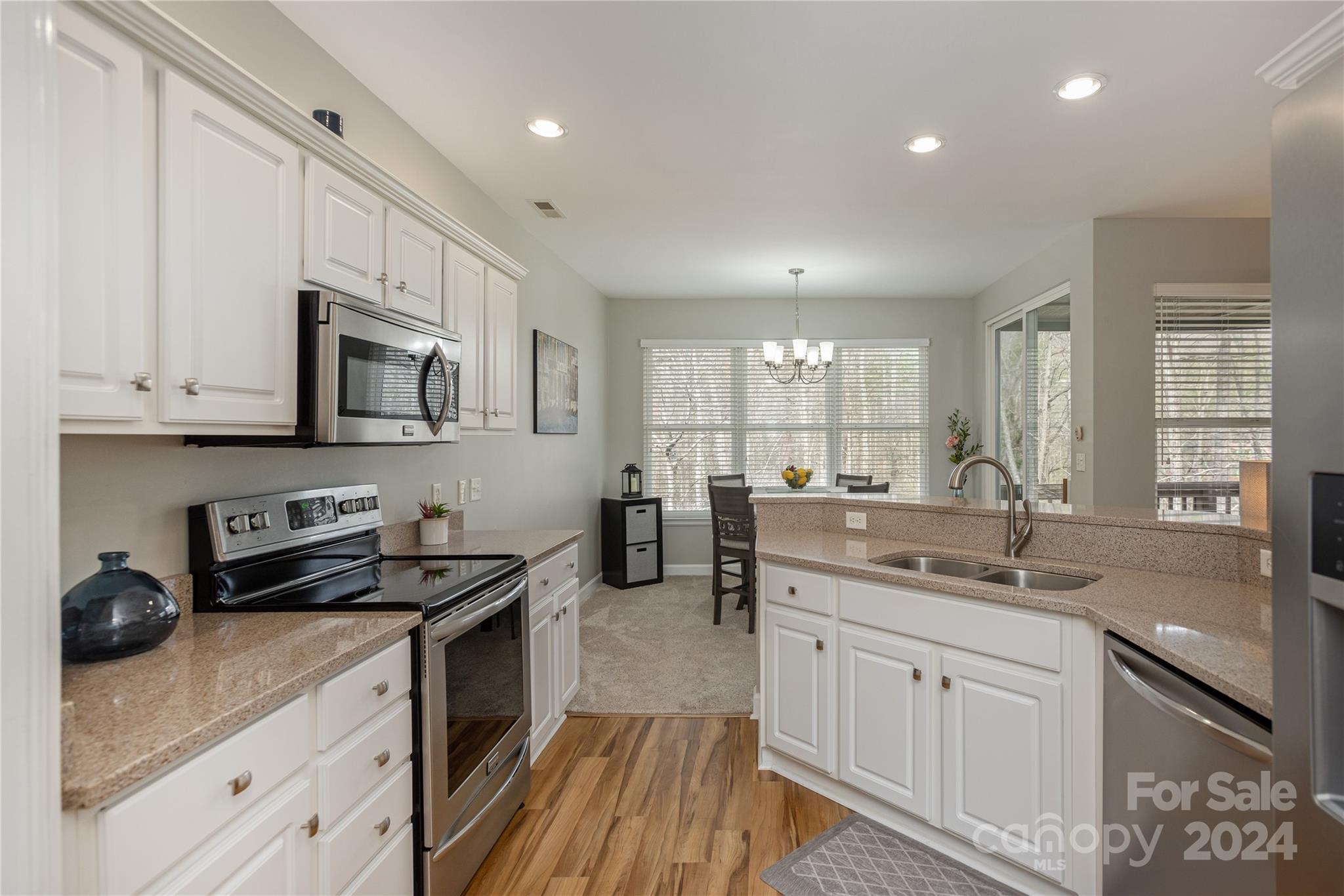 99 Ridgetop Circle, Unit 203 Brevard, NC 28712 - Photo 12 of 36 a kitchen with a sink stove and cabinets