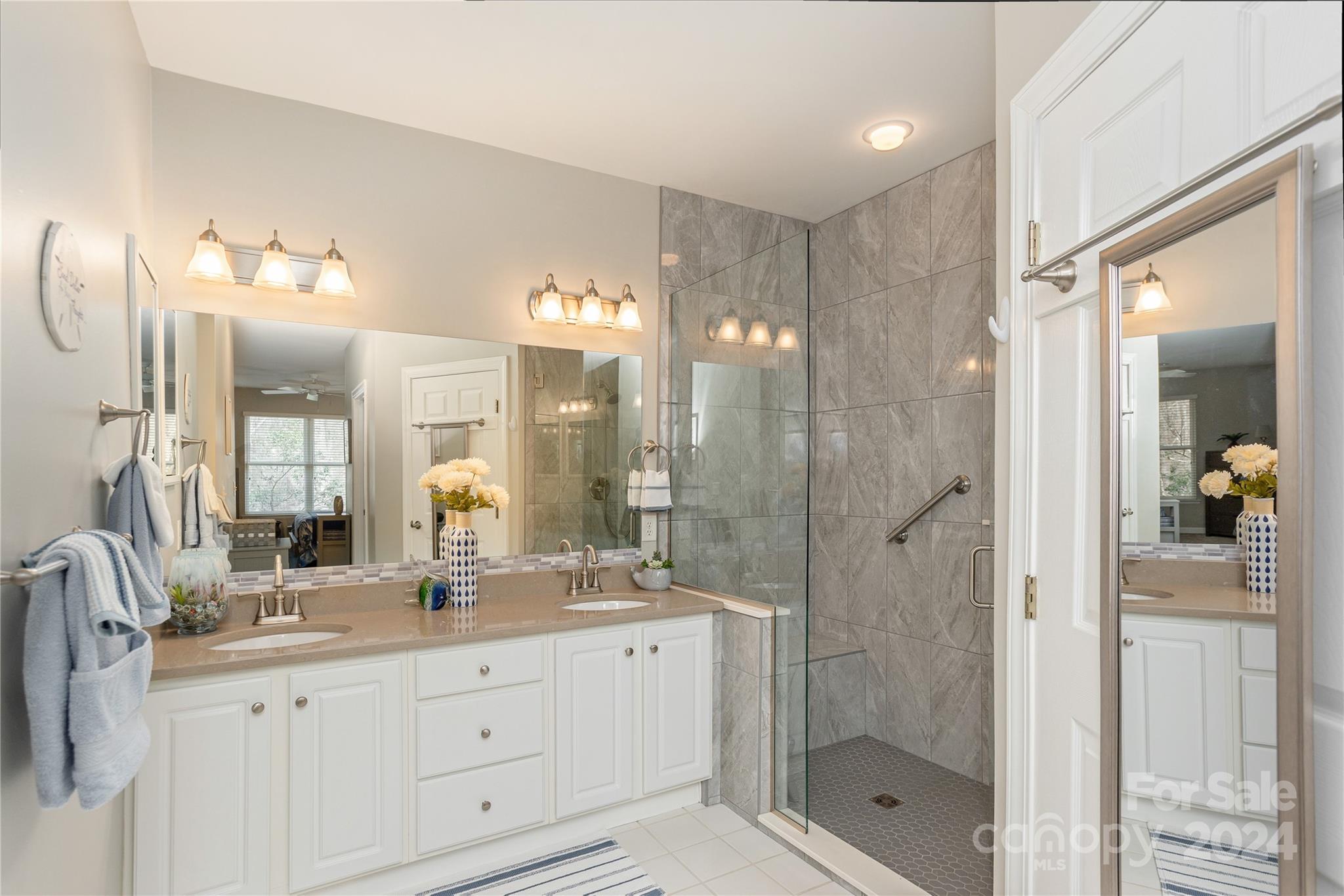 99 Ridgetop Circle, Unit 203 Brevard, NC 28712 - Photo 17 of 36 a bathroom with a shower sink double and mirror