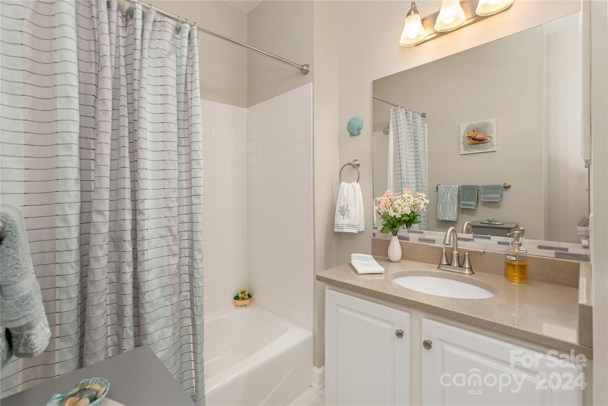 99 Ridgetop Circle, Unit 203 Brevard, NC 28712 - Photo 20 of 36 a bathroom with a granite countertop sink and a mirror