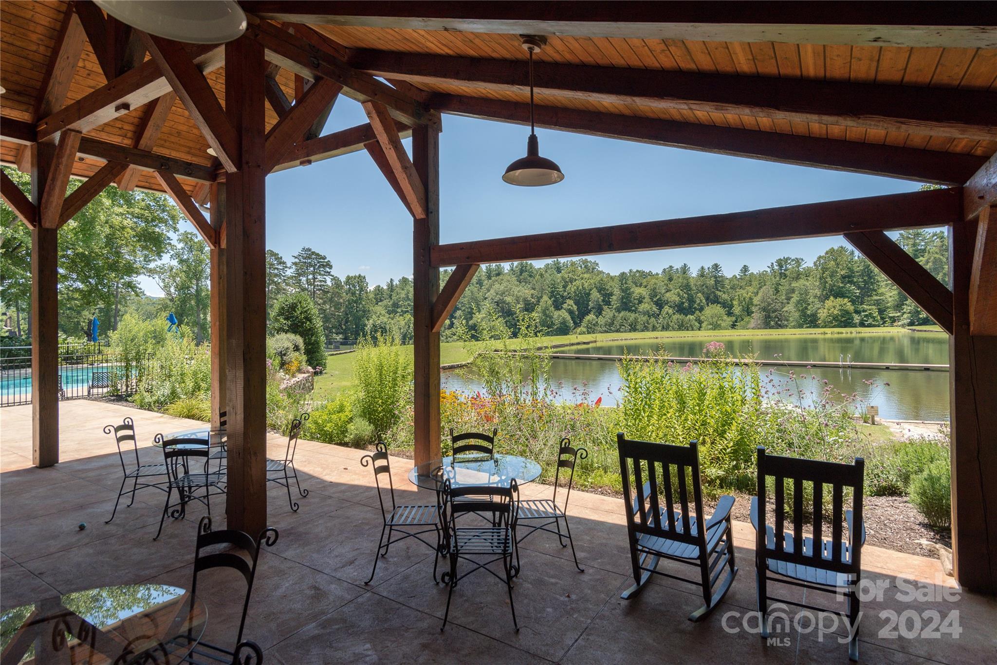 99 Ridgetop Circle, Unit 203 Brevard, NC 28712 - Photo 29 of 36 a view of a chairs and table in patio
