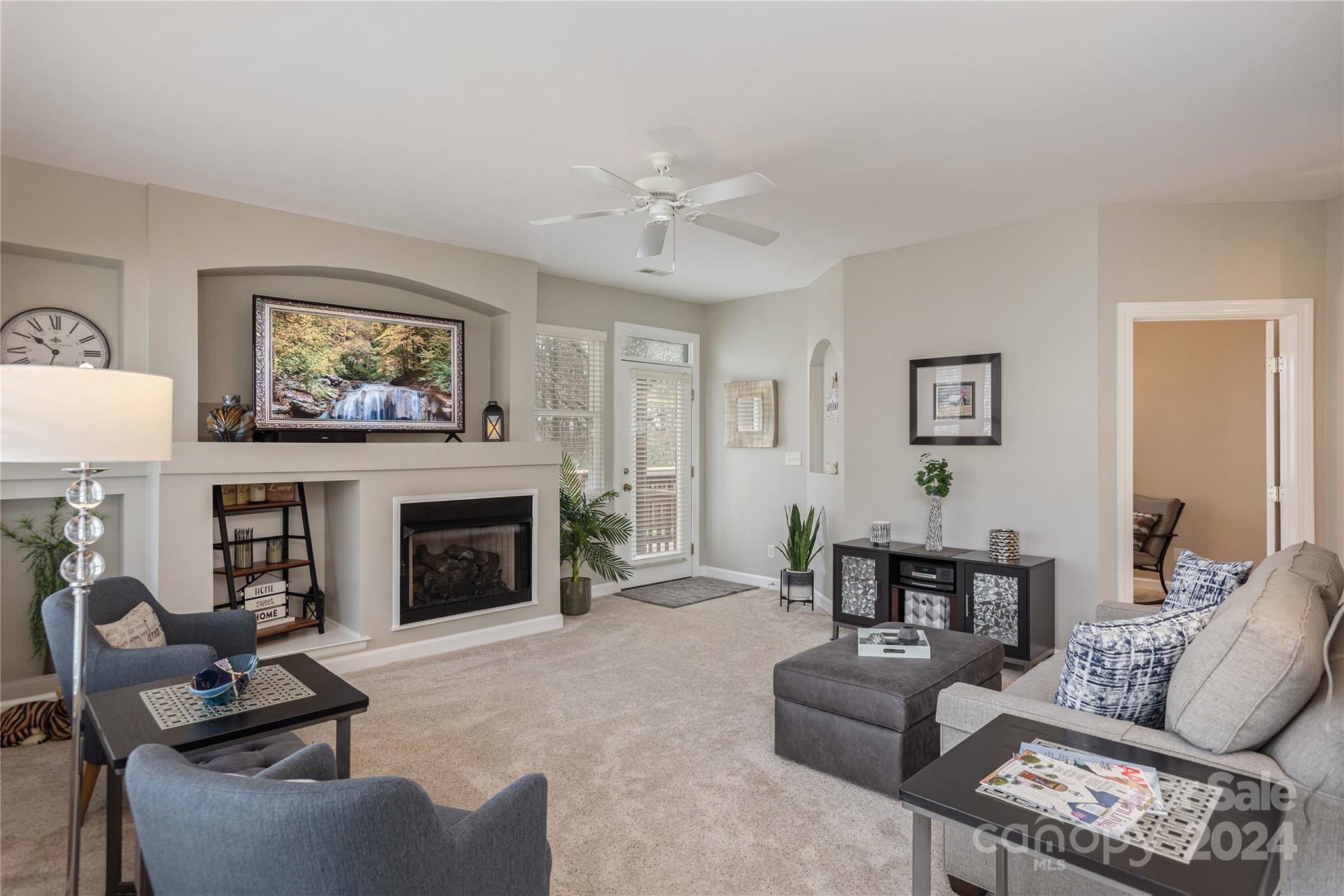 99 Ridgetop Circle, Unit 203 Brevard, NC 28712 - Photo 5 of 36 a living room with furniture a fireplace and a table