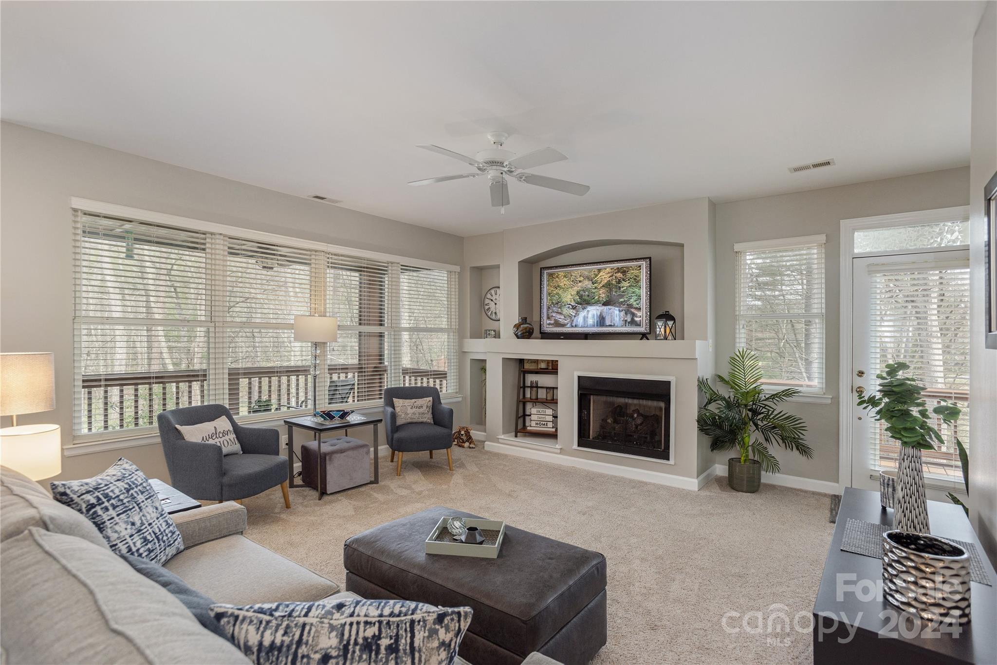 99 Ridgetop Circle, Unit 203 Brevard, NC 28712 - Photo 6 of 36 a living room with furniture and a fireplace