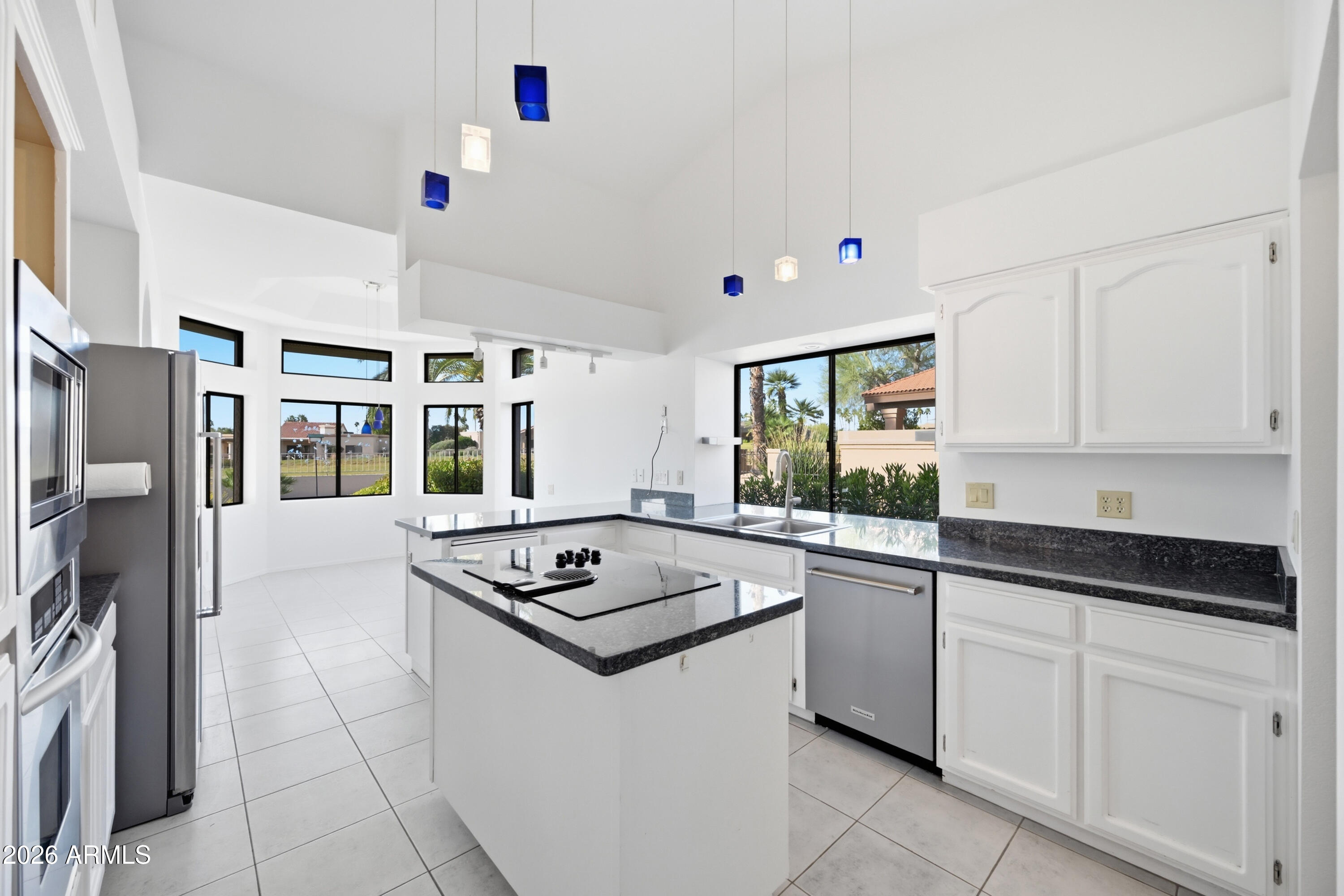 19113 East Vía Esquina Rio Verde, AZ 85263 - Photo 11 of 44 a kitchen with stainless steel appliances granite countertop a sink stove and refrigerator