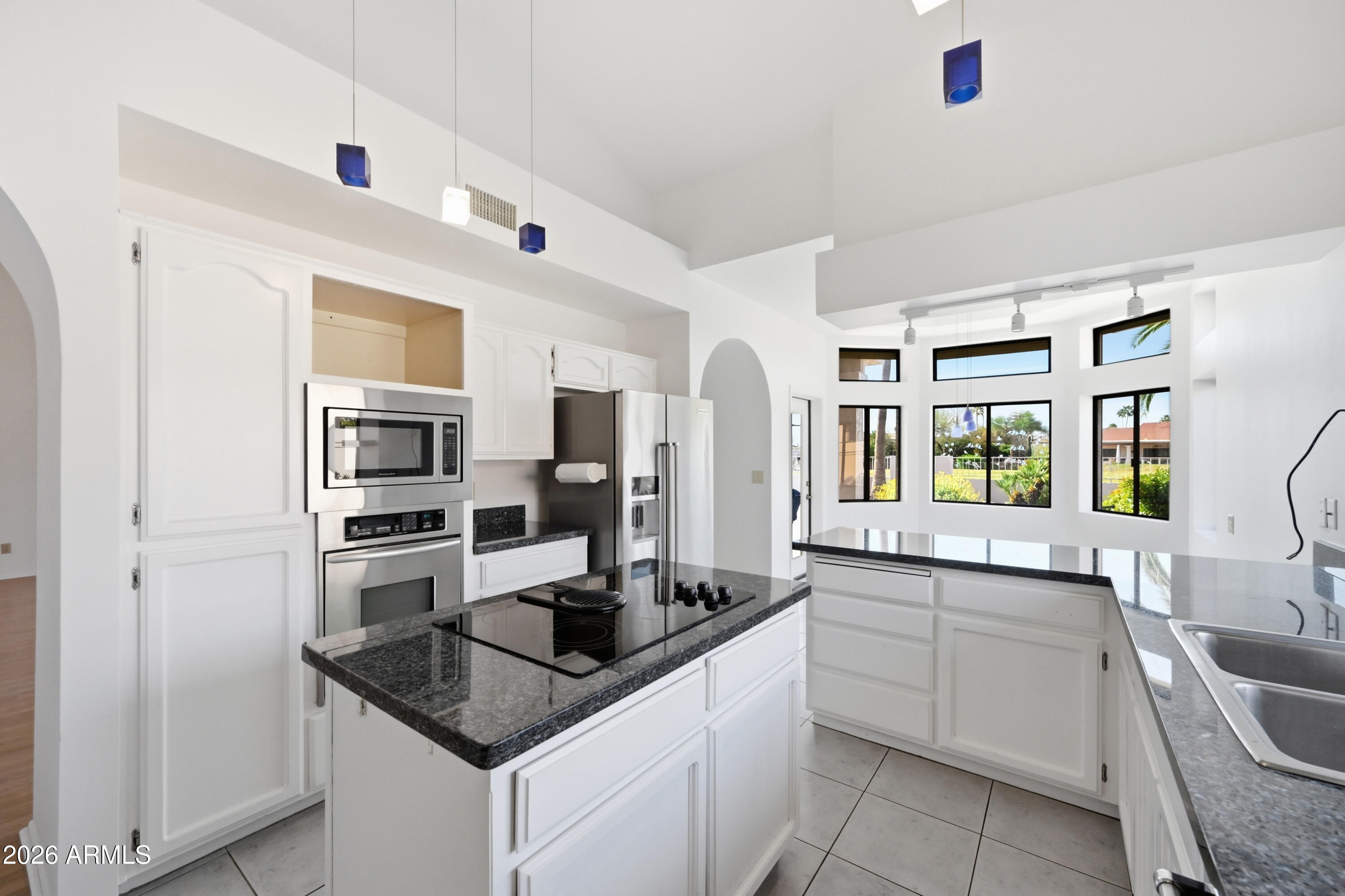 19113 East Vía Esquina Rio Verde, AZ 85263 - Photo 13 of 44 a kitchen with stainless steel appliances granite countertop a sink stove and refrigerator