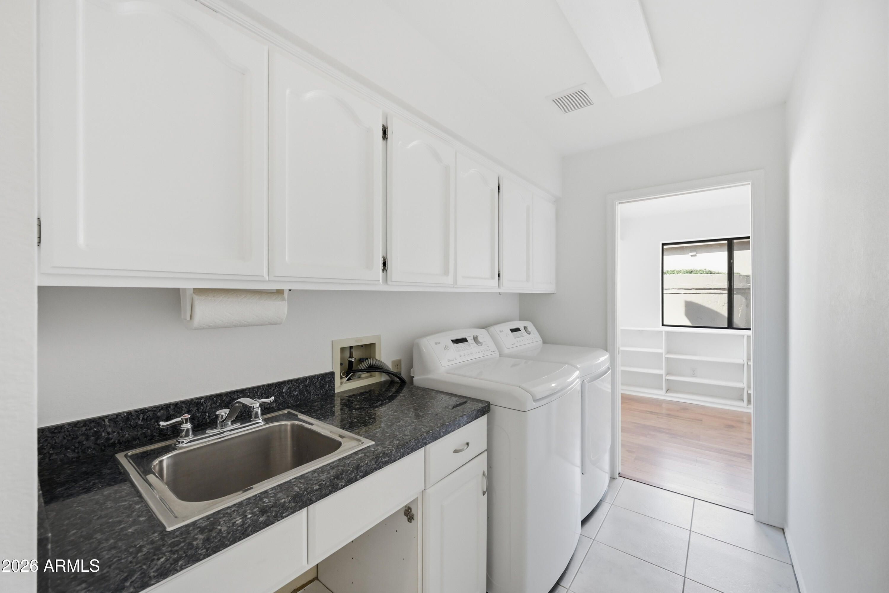 19113 East Vía Esquina Rio Verde, AZ 85263 - Photo 14 of 44 a kitchen with white cabinets a sink and dishwasher