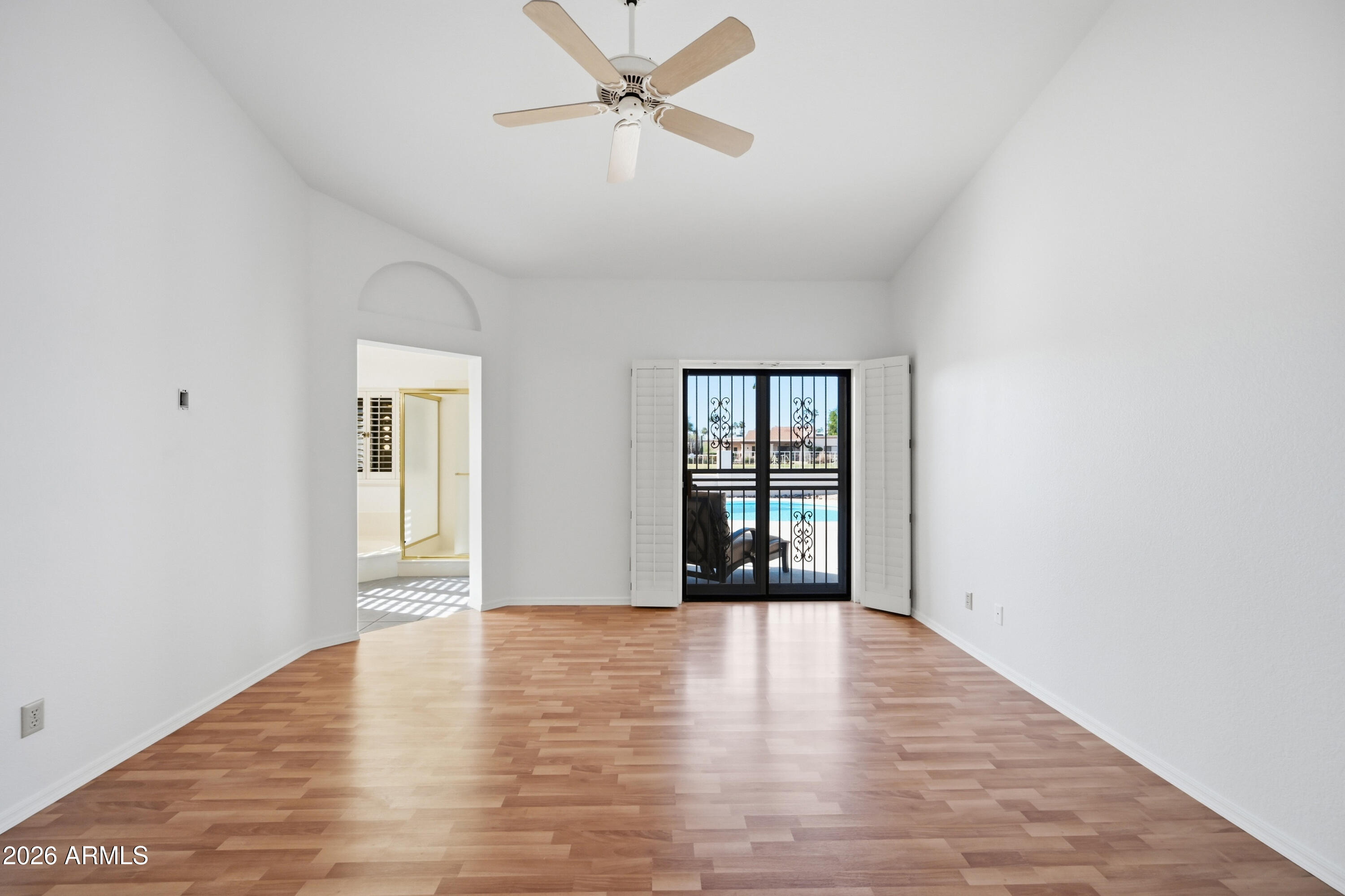 19113 East Vía Esquina Rio Verde, AZ 85263 - Photo 19 of 44 a view of an empty room with window and wooden floor