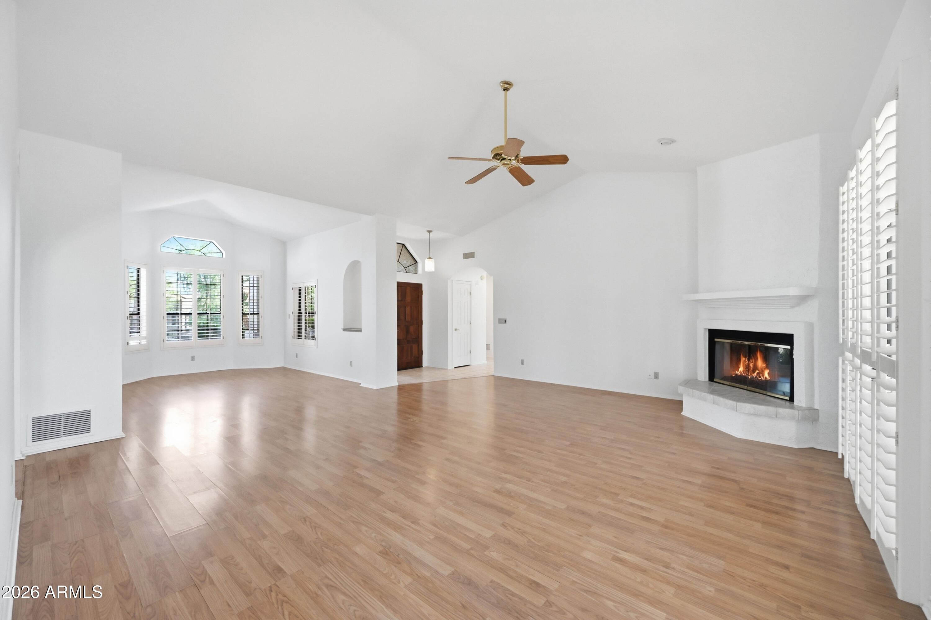 19113 East Vía Esquina Rio Verde, AZ 85263 - Photo 7 of 44 a view of an empty room with a fireplace and wooden floor