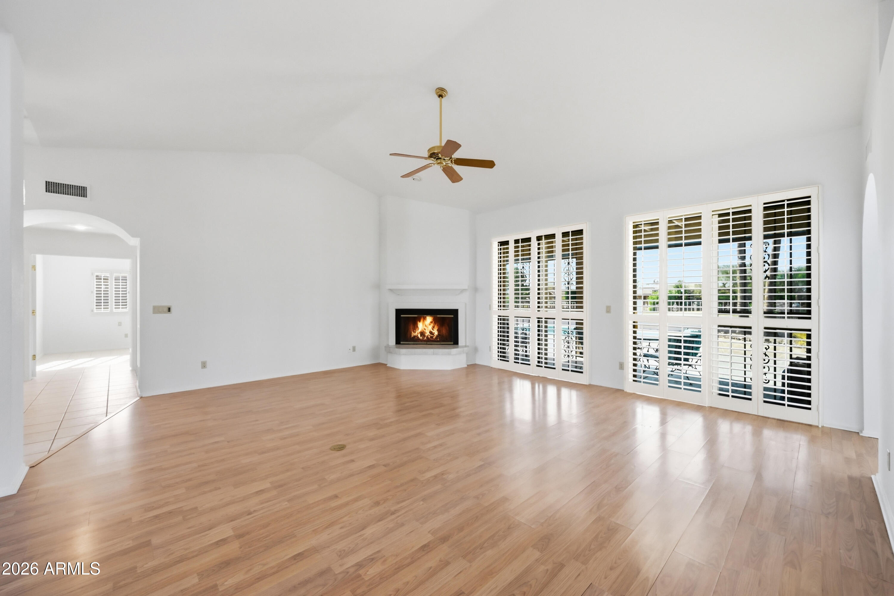19113 East Vía Esquina Rio Verde, AZ 85263 - Photo 8 of 44 a view of an empty room with wooden floor and a window