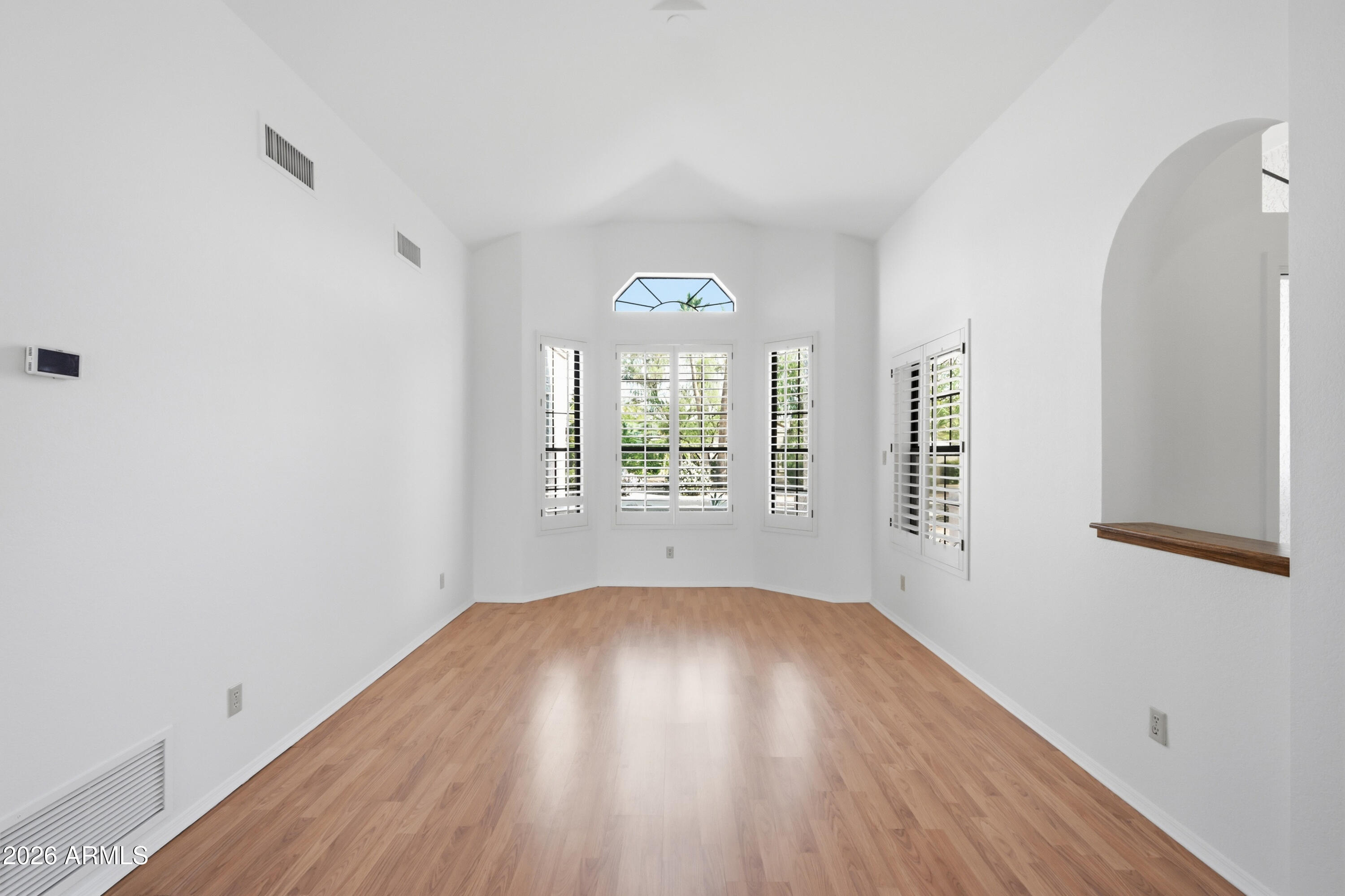 19113 East Vía Esquina Rio Verde, AZ 85263 - Photo 9 of 44 an empty room with wooden floor and windows