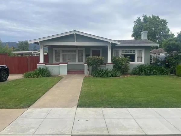 a front view of house with yard and green space