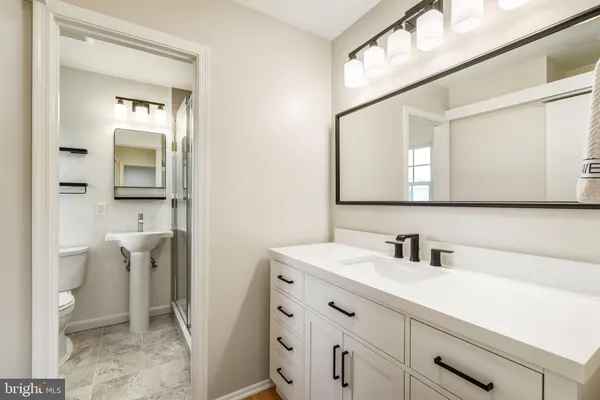 a bathroom with a toilet sink and shower