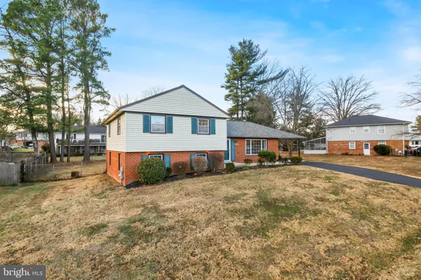 a view of a house with a yard covered in snow