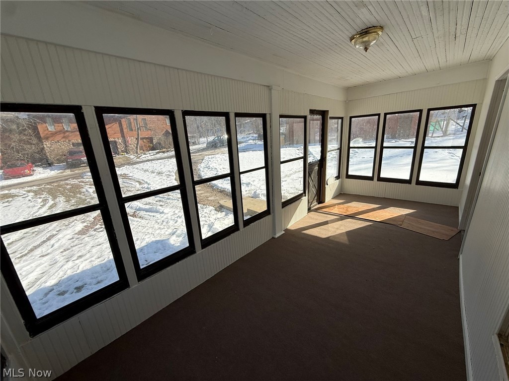 6784 Old Zoarville Road Northeast Dover, OH 44622 - Photo 9 of 50 Unfurnished sunroom featuring concrete floors