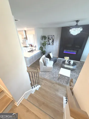 a living room with furniture and a chandelier