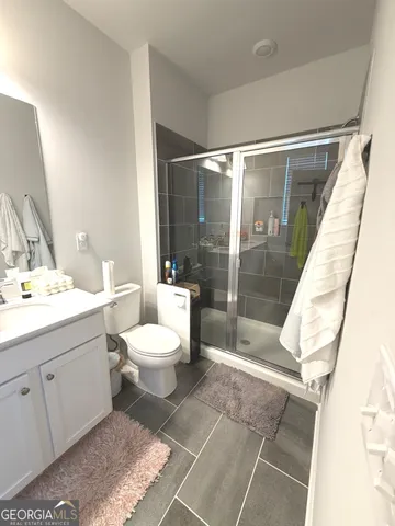 a bathroom with a toilet sink and shower