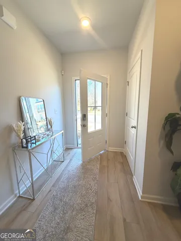 a view of an entryway with wooden floor